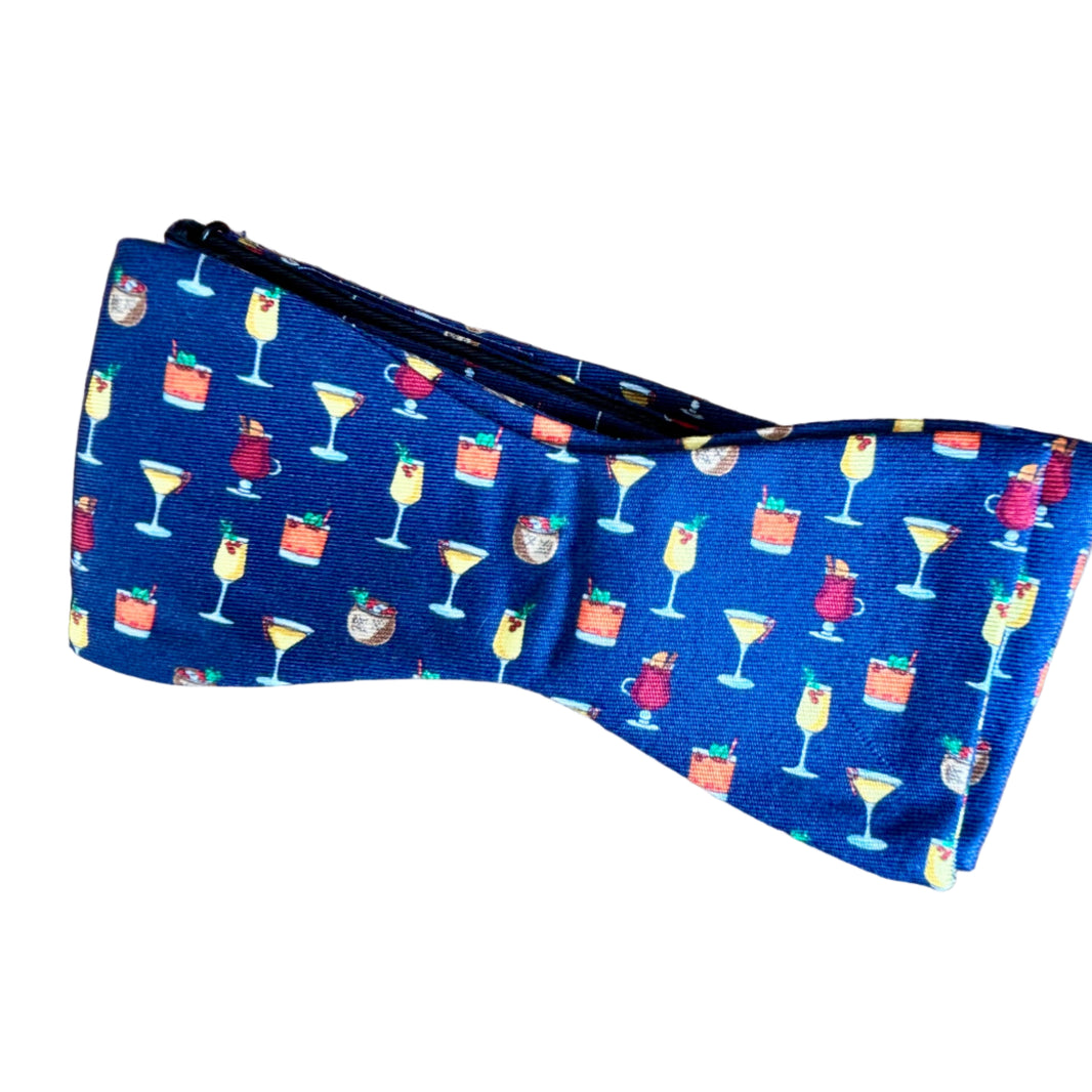 Blue pouch with colorful drink patterns on a white surface