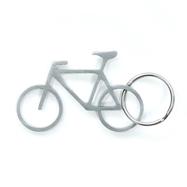 Silver bicycle-shaped bottle opener and keyring on a white background