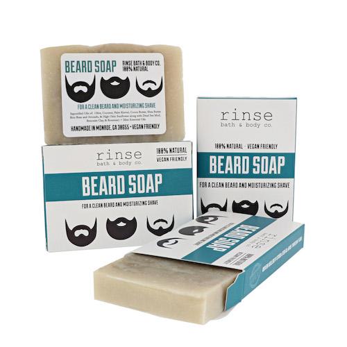 A packaged bar soap labeled 'BEARD SOAP' by Rinse Bath & Body, indicating it is designed for beard care.