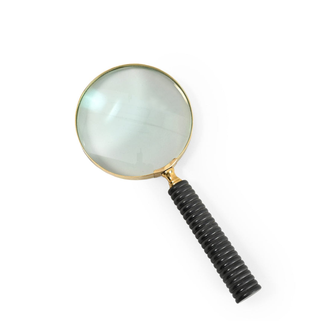 A magnifying glass with a black ribbed handle on a white background.