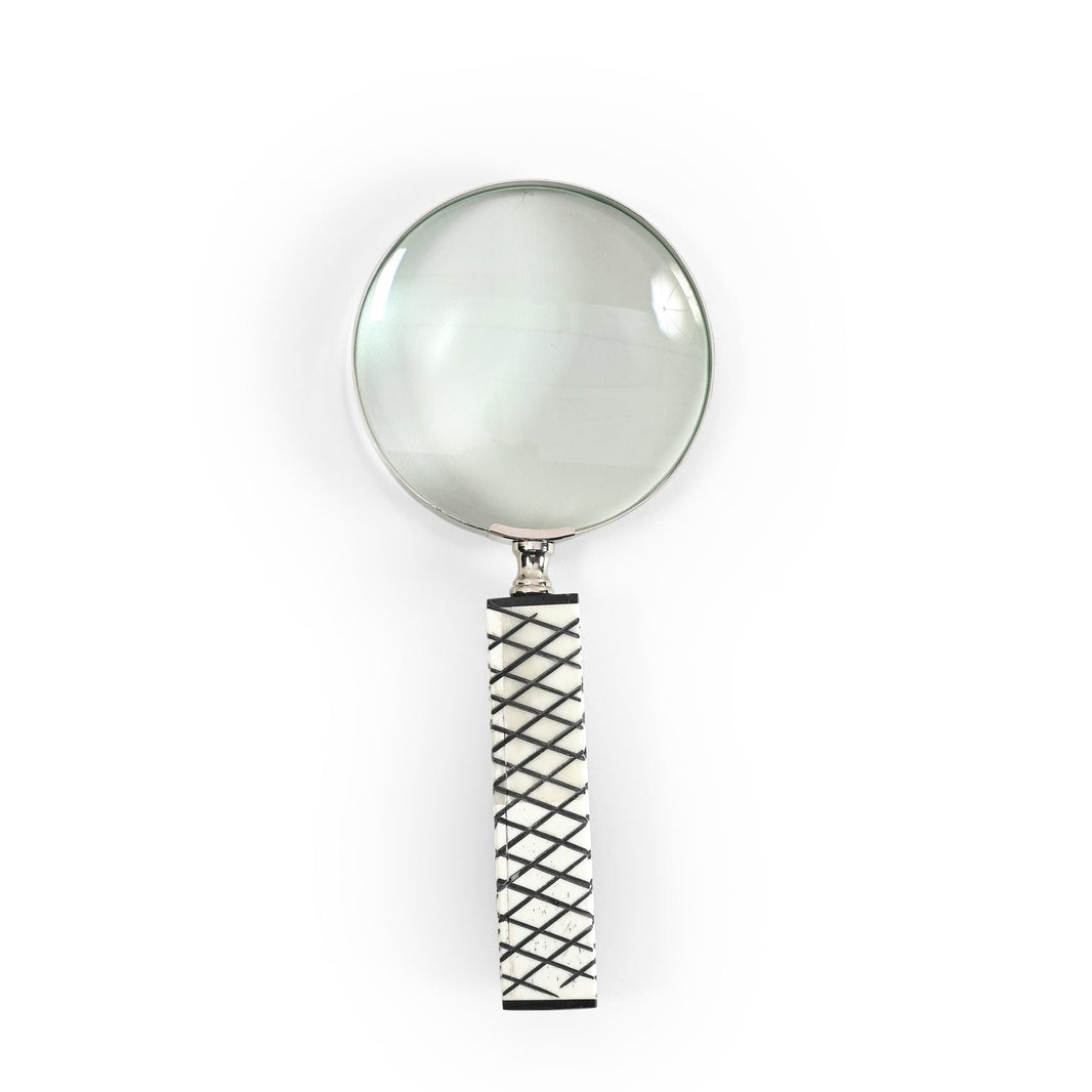 Magnifying glass with a black and white handle on a white background