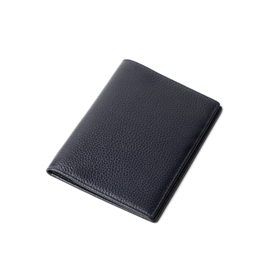 A dark blue genuine leather passport holder with satin stitching, closed and displayed against a white background.