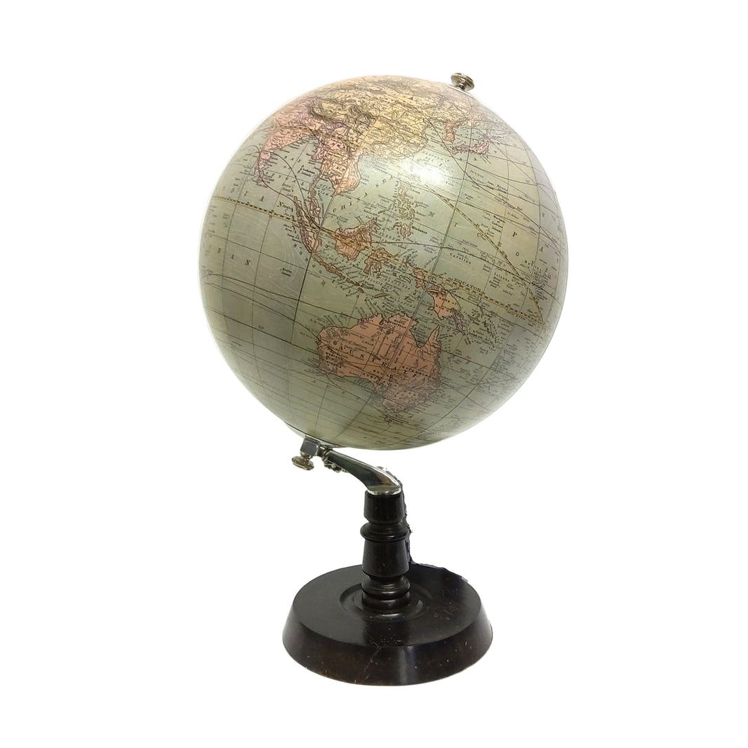 A stylish Chicago deco globe with a wooden base, featuring a map of the world on a silver and black stand.