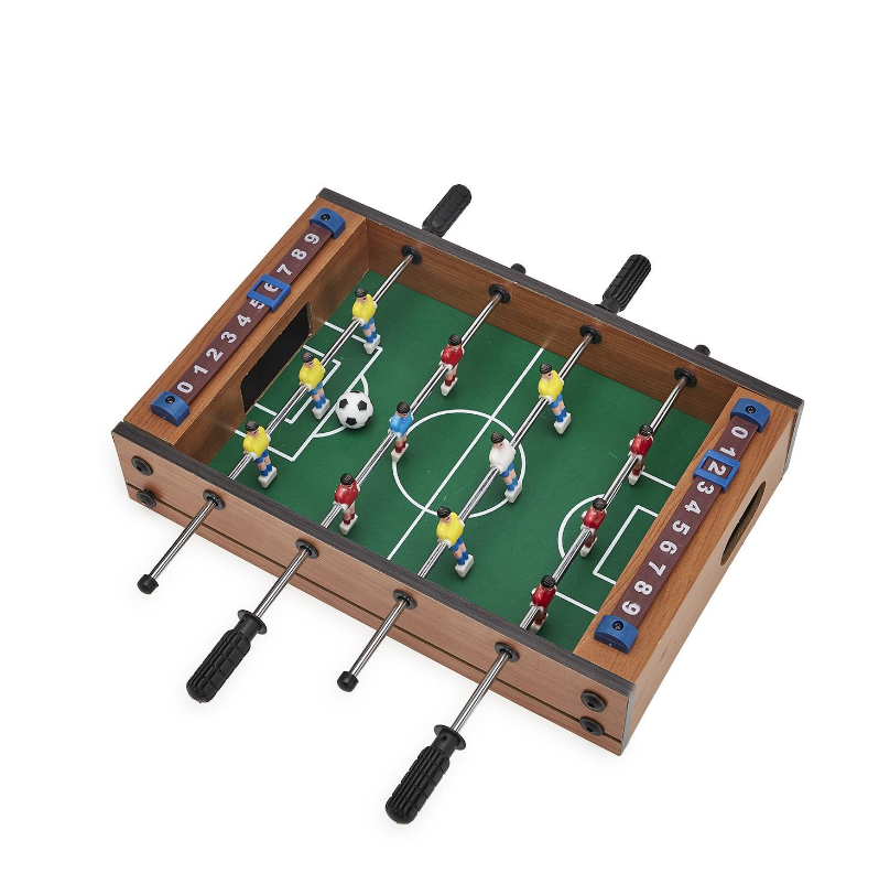 A miniature soccer foosball game set with colorful figures on a green playing surface, surrounded by a brown wooden frame, designed for tabletop play.
