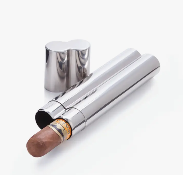 A stainless steel double cigar holder with one cigar partially extended from it.