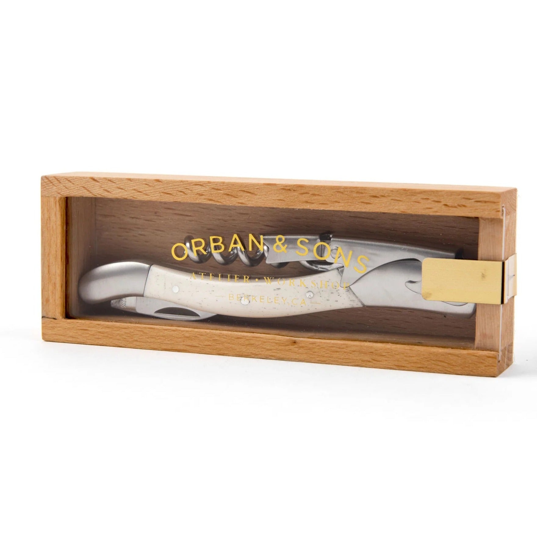 Corkscrew, knife, and bottle opener tool with bone handle in wooden box with an acrylic lid that says "Orban & Sons"