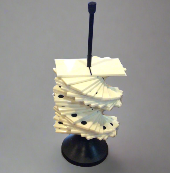 A set of domino tiles displayed on a black stand, against a neutral background.