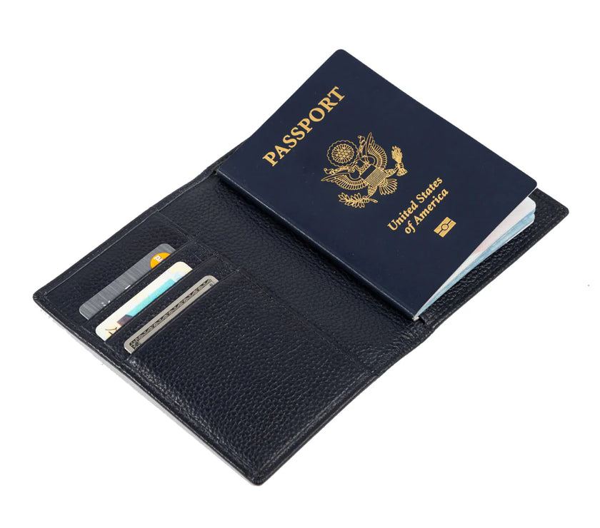 Black leather passport holder with a U.S. passport and credit cards inside on a white background