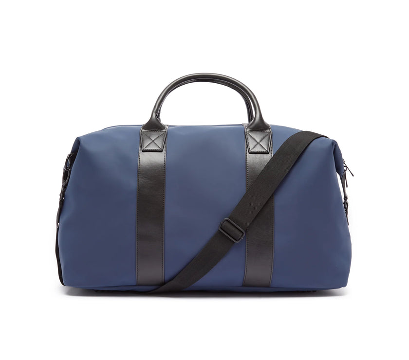 Blue duffel bag with black straps on a white background