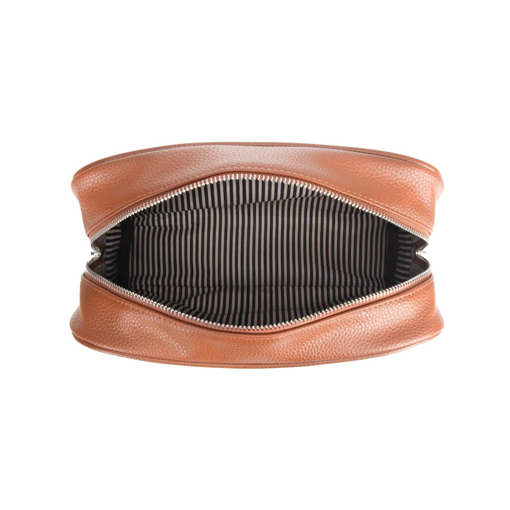 Brown leather toiletry bag with striped interior on a white background