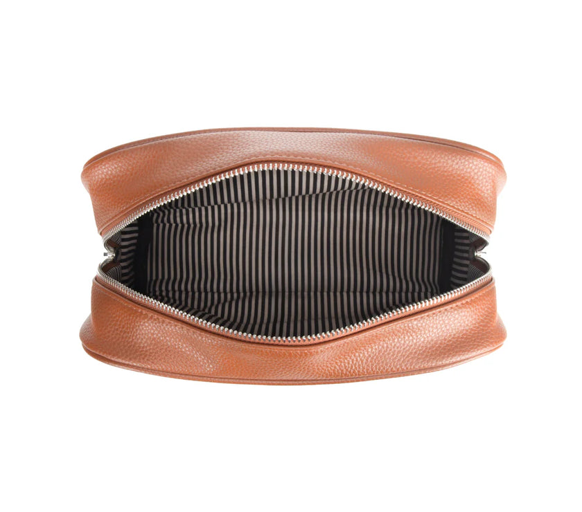 Brown leather toiletry bag with striped interior on a white background