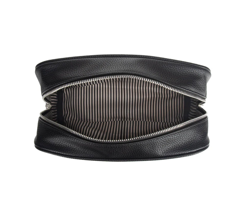 Black toiletry bag with the zipper open to show a striped black and white interior on a white background