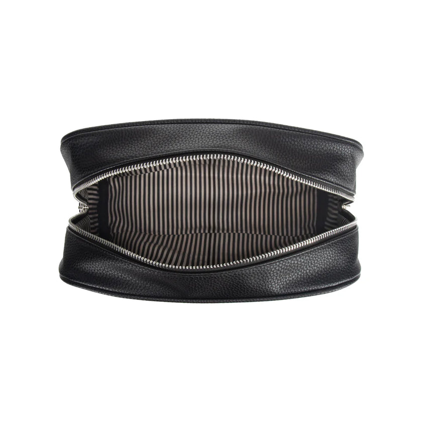 Black toiletry bag with the zipper open to show a striped black and white interior on a white background