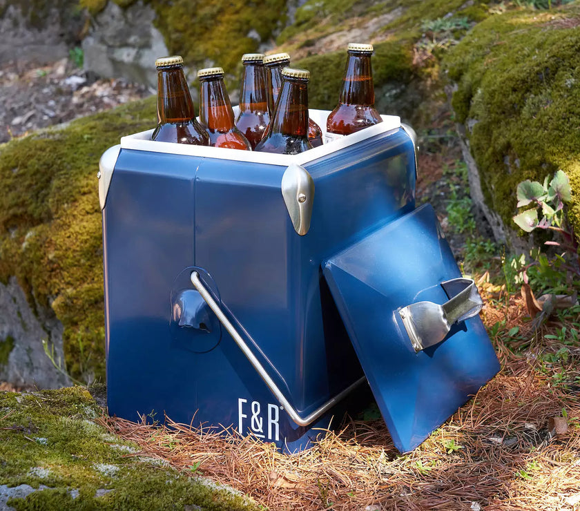 Blue cooler with 'F&R' branding holding six bottles outdoors.