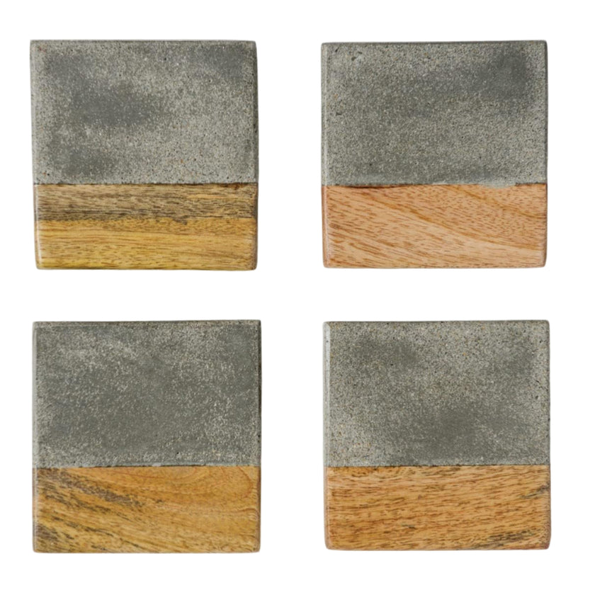 Four square coasters with a two-tone design of gray cement and wood on a white background.