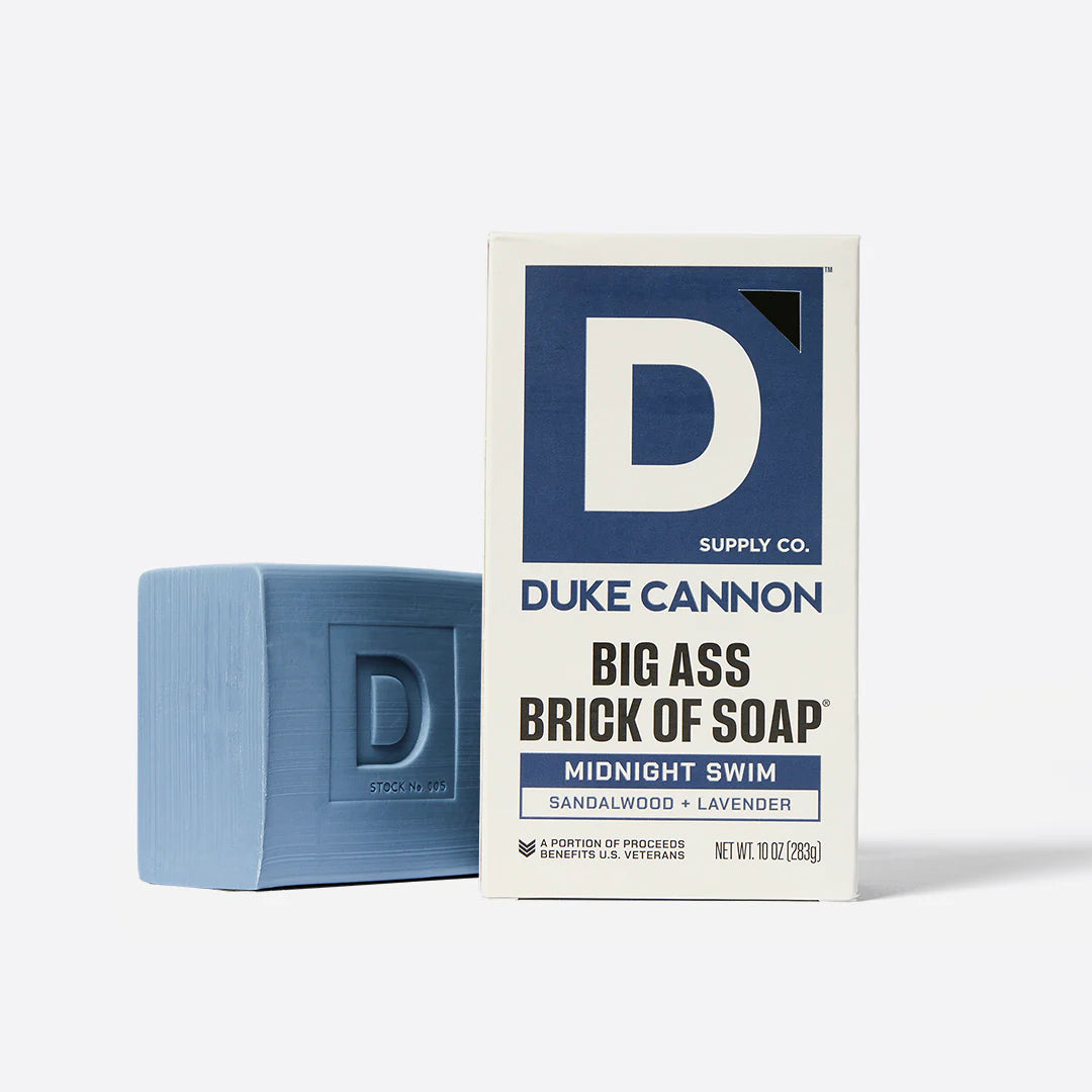Blue bar of soap and Duke Cannon packaging on a white background