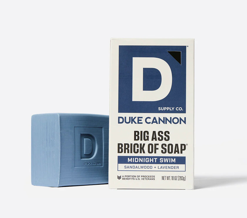 Blue bar of soap and Duke Cannon packaging on a white background