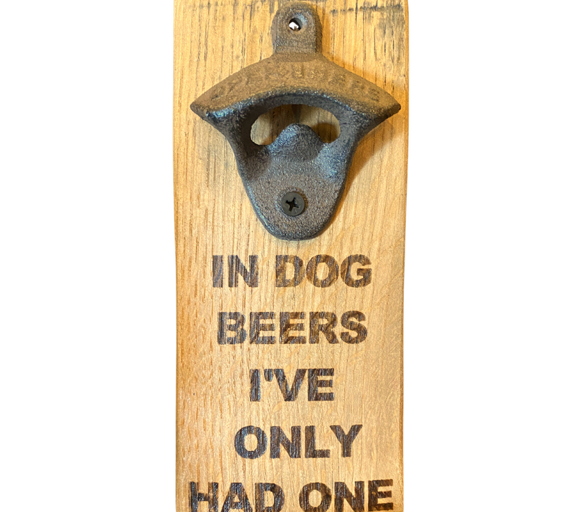 A barrel stave fashioned into a bottle opener with the words "in dog beers I've only had one" on it