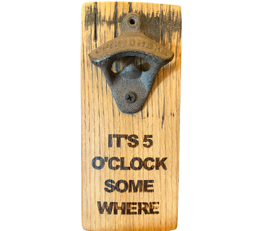 A barrel stave fashioned into a bottle opener with the words "its 5 o'clock somewhere" on it