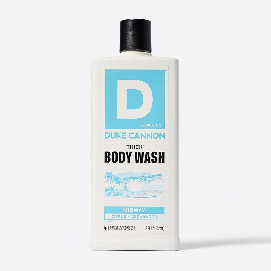 A white plastic bottle with a black cap labeled 'Duke Cannon THICK Body Wash' with a graphic of a flag and text indicating the scent 'Midway'.