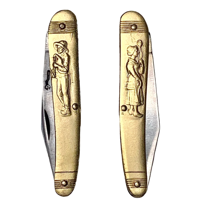 Two gold pocket knives with engraved figures on a white background