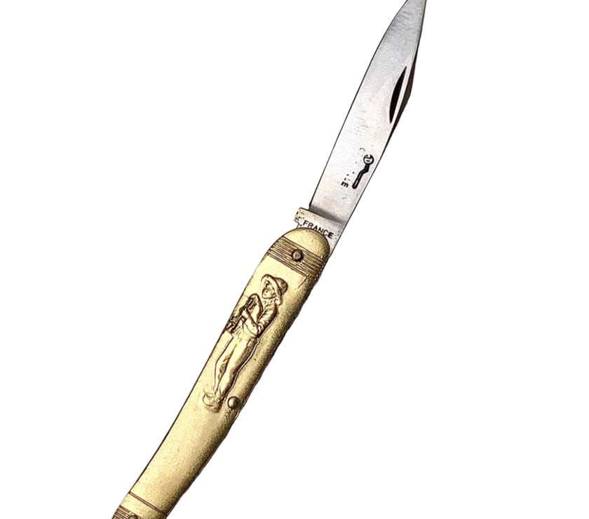 Decorative knife with gold handle and engraved design on a white background