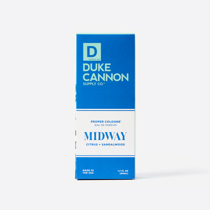 The packaging box for Duke Cannon's Proper Cologne in scent Midway, with blue and white coloring and lettering.