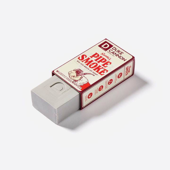 Duke Cannon Big Ass Brick of Soap with 'Santa's Pipe Smoke' scent, featuring an illustration of a pipe and Santa Claus.