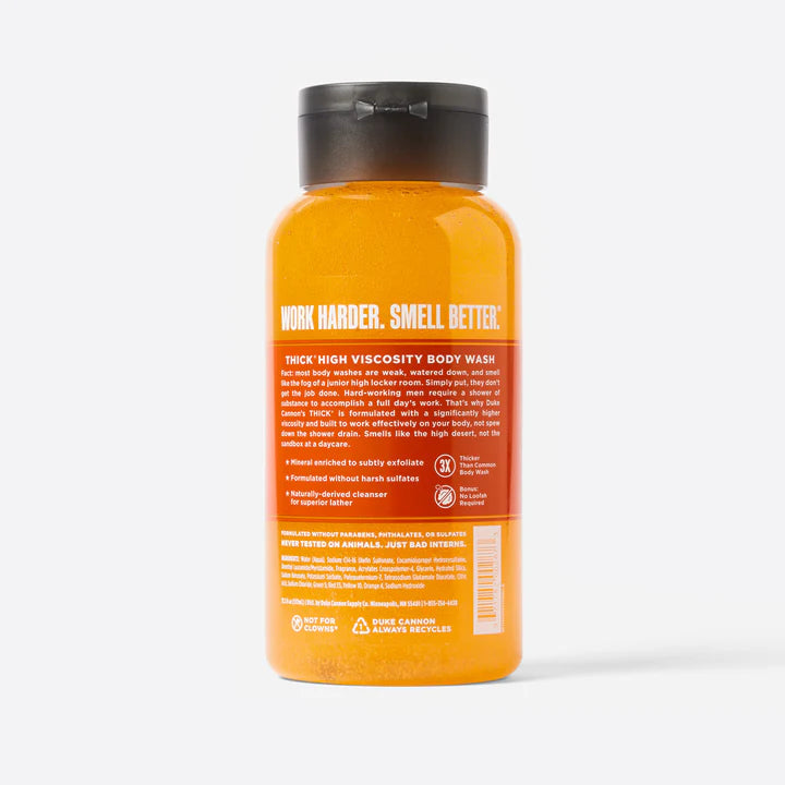The back label of a bottle of Duke Cannon THICK Body Wash - Wayfinder with orange liquid and a black cap.