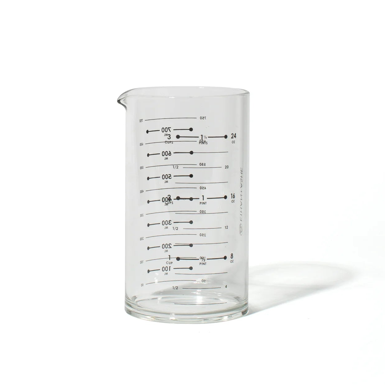 Clear glass beaker with measurement markings on a white background