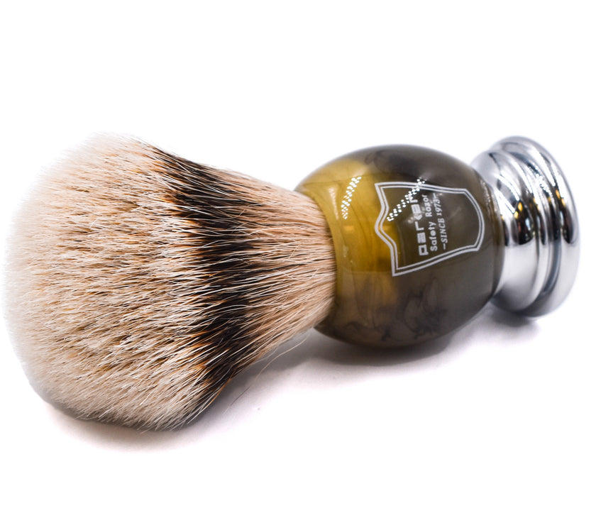 Shaving brush with brown faux horn handle and silver ferrule on a white background