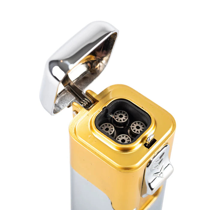 A gold accented butane cigar lighter with the silver lid flipped up to show the interior lighting mechanisms inside.