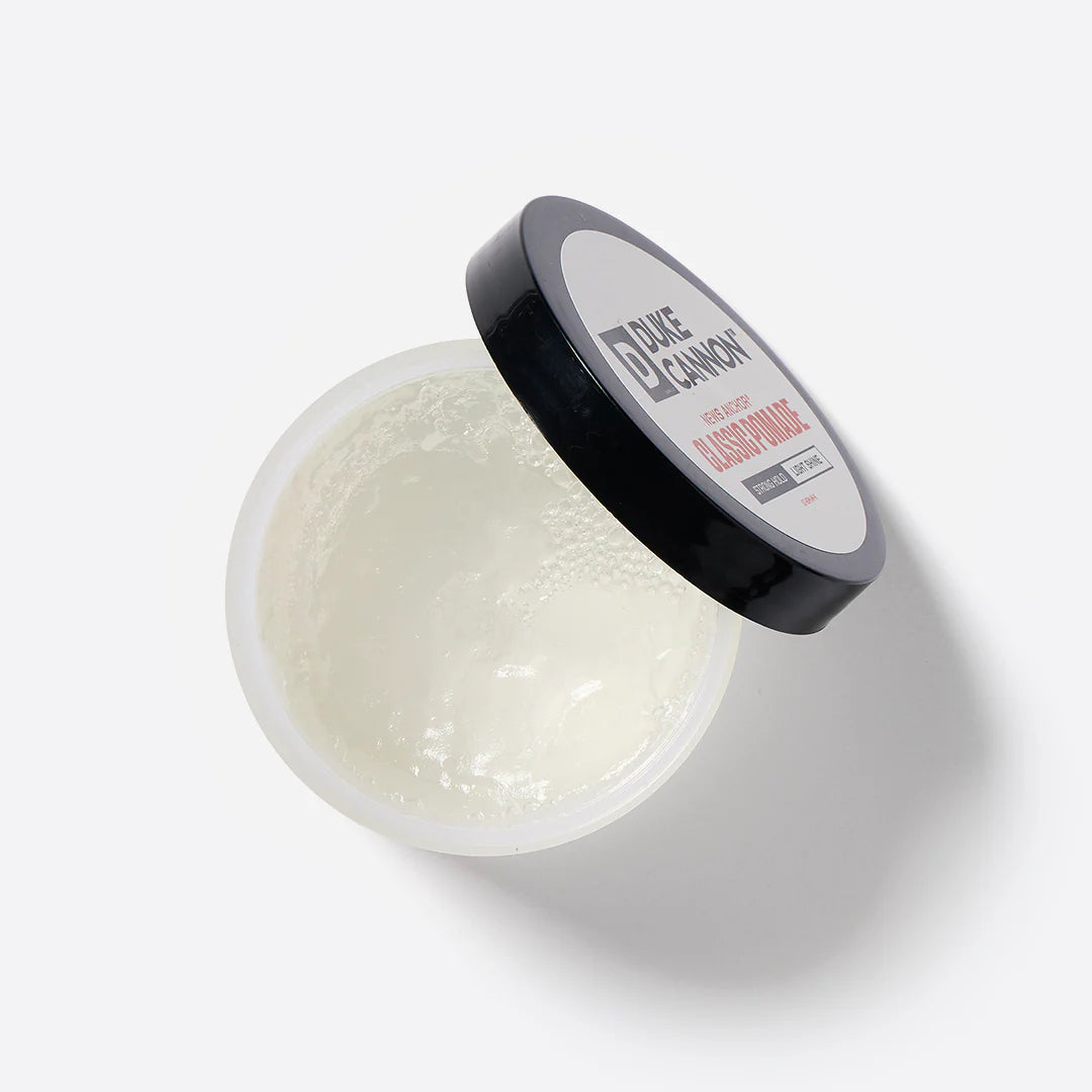 An open container of Duke Cannon Classic Pomade to show the product inside.