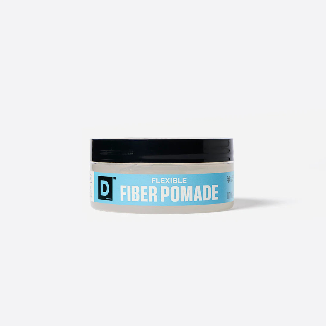 Jar of Duke Cannon flexible fiber pomade with a blue label on a white background