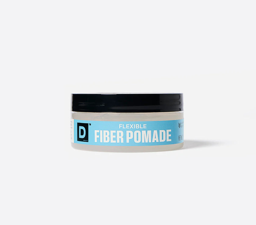 Jar of Duke Cannon flexible fiber pomade with a blue label on a white background