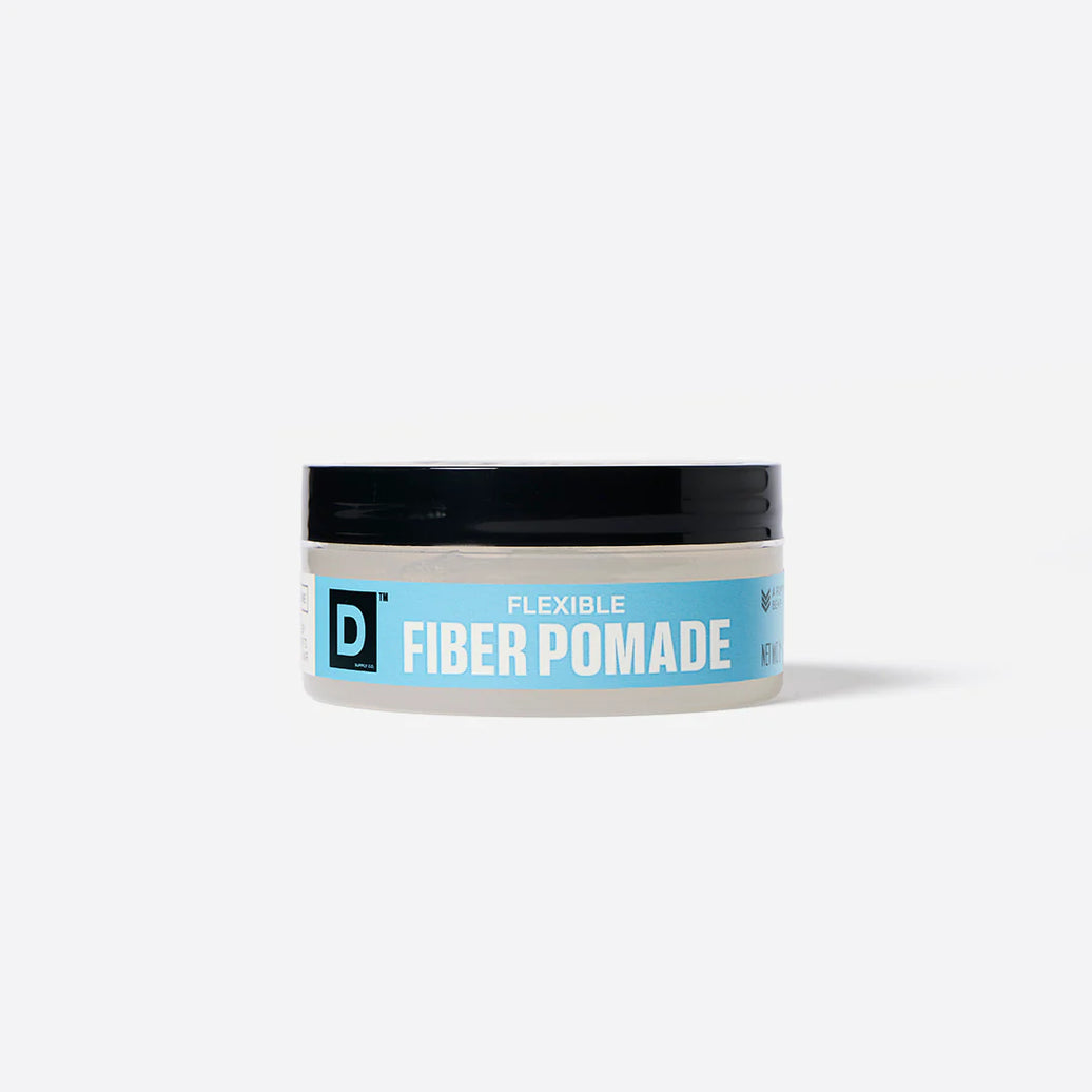 Jar of Duke Cannon flexible fiber pomade with a blue label on a white background