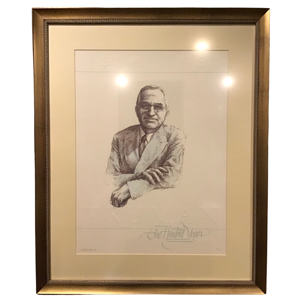 Framed black and white portrait of Harry Truman with a signature at the bottom right corner.