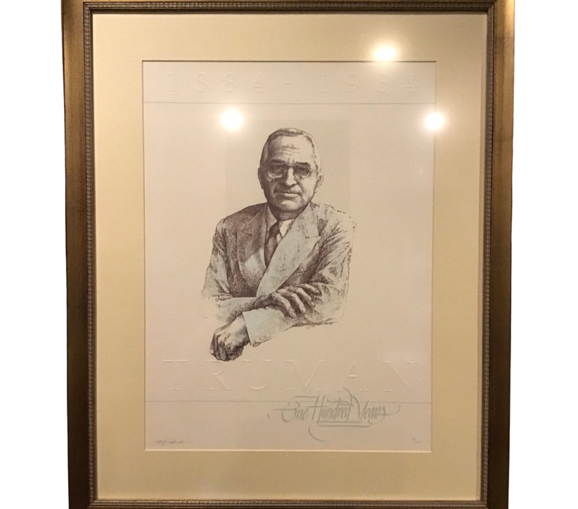 Framed black and white portrait of Harry Truman with a signature at the bottom right corner.