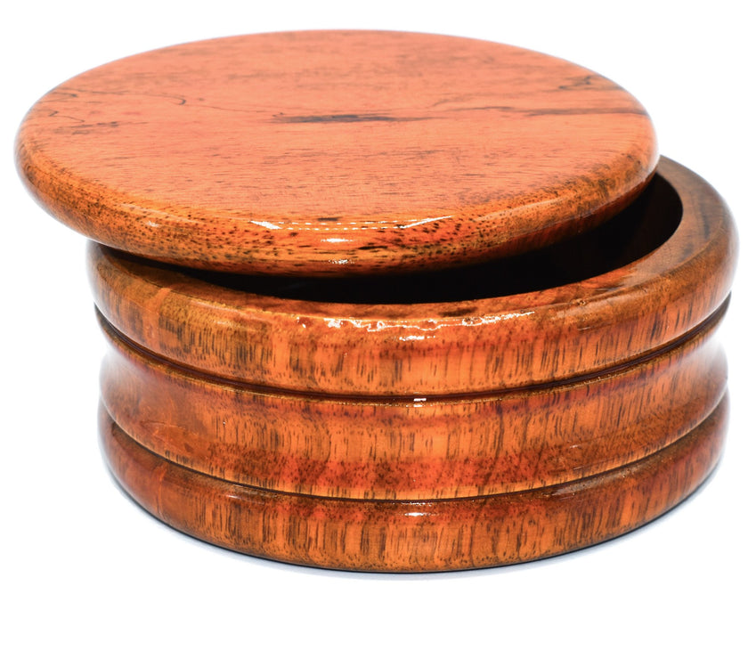 A honey-colored mango wood shave bowl with a lid, displaying the grain of the wood.