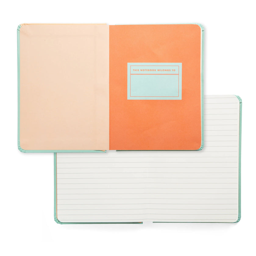 Two open notebooks; one shows the "this notebook belongs to" page and the other shows lined pages.