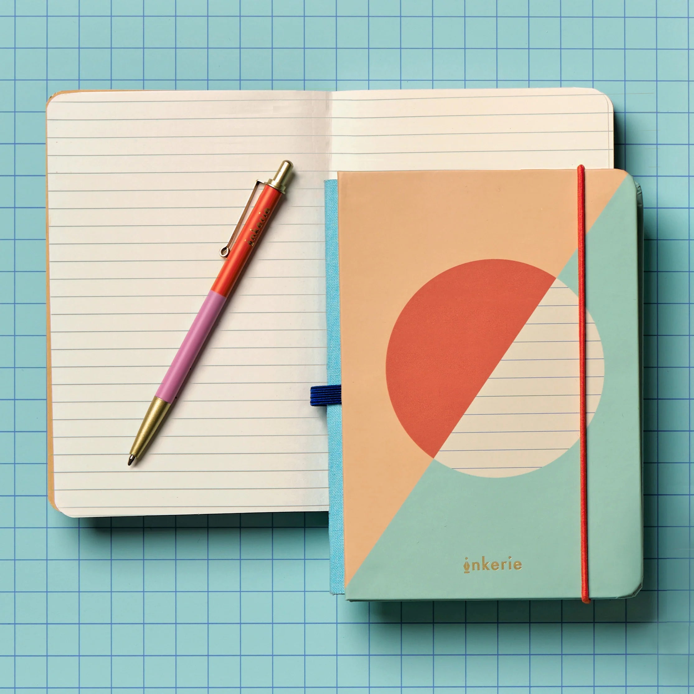 Notebook with geometric design cover and pen on a grid background