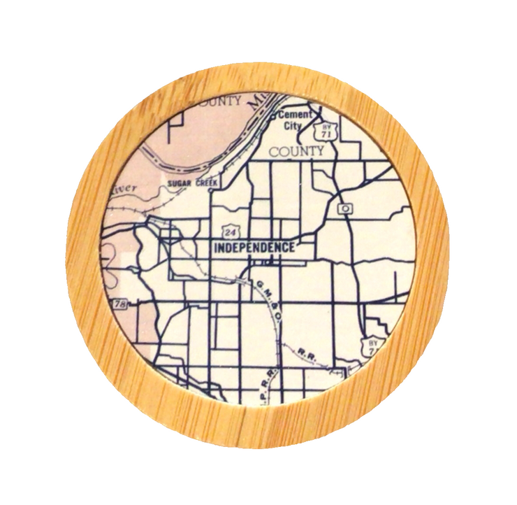 A round bamboo bottle opener with a map of Independence, Missouri, in the center.