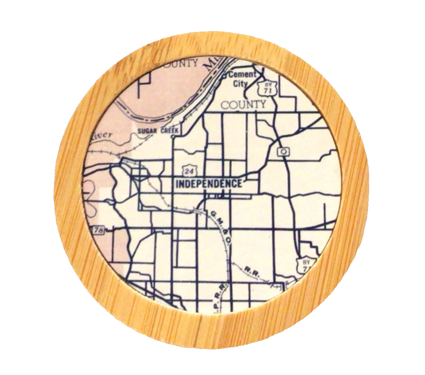 A round bamboo bottle opener with a map of Independence, Missouri, in the center.