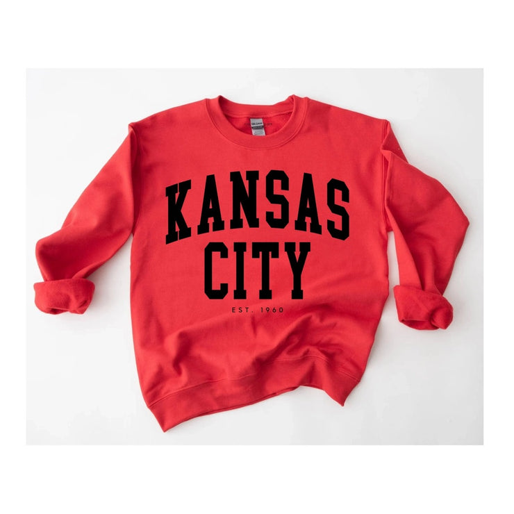Red sweatshirt with 'Kansas City EST 1960' text on a white background