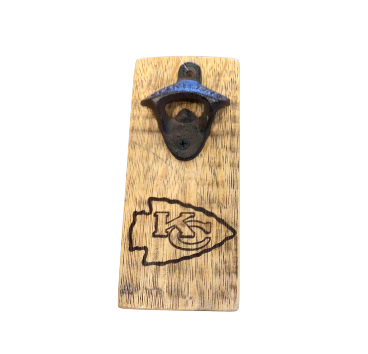 A wooden bottle opener with a Kansas City Chiefs logo engraved on it, against a grey background.