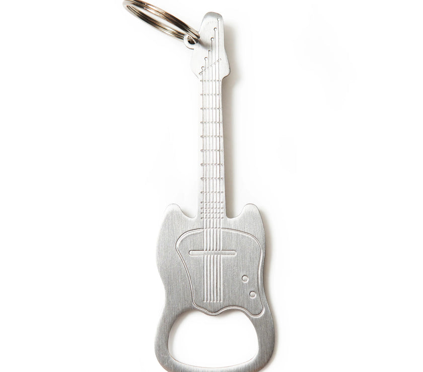 A bottle opener as a keychain in the shape of a guitar.
