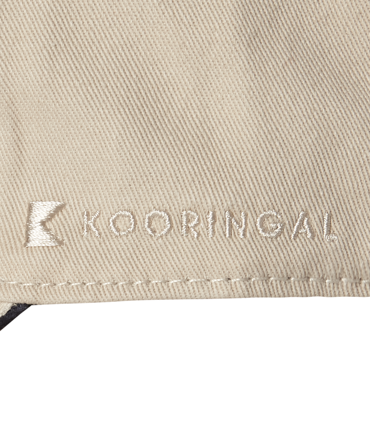 A closeup of the Kooringal logo done in stitching on the edge of a baseball cap.