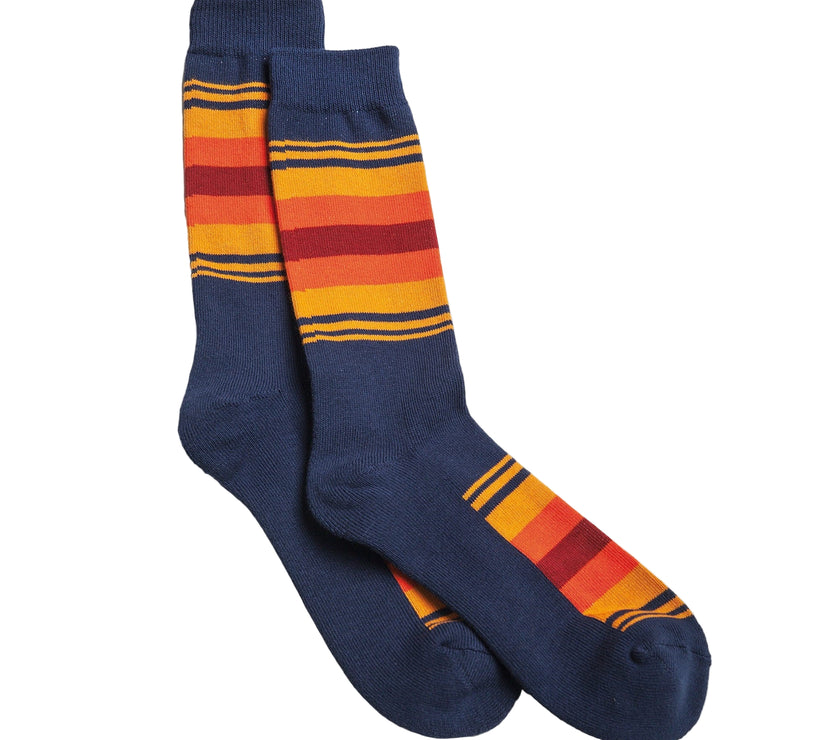 Pair of blue socks with orange and red striped pattern on a white background