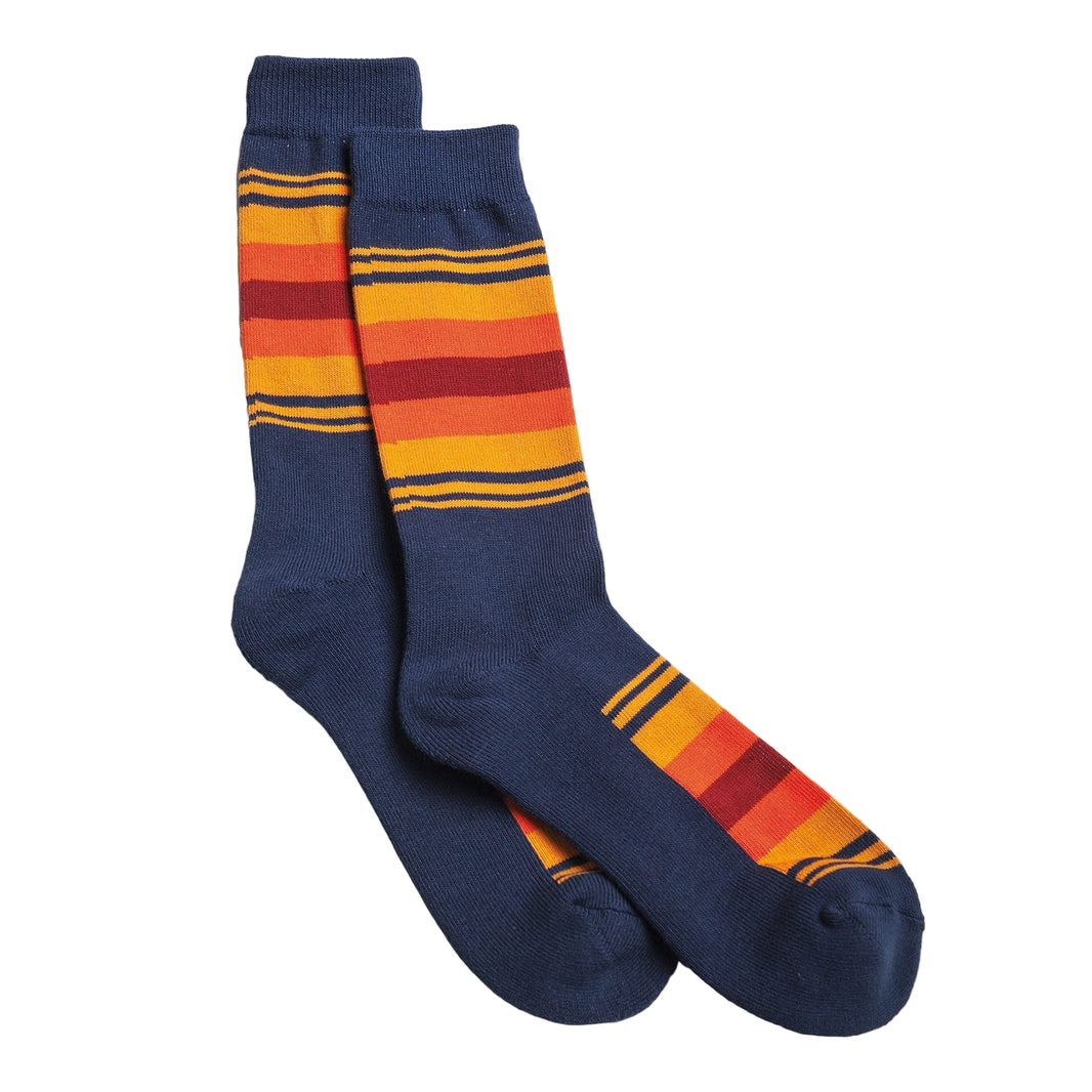 Pair of blue socks with orange and red striped pattern on a white background