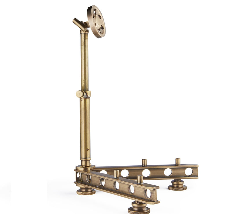 Brass gadget stand on a white background